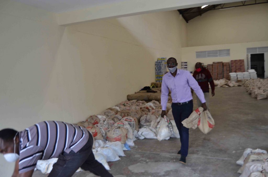 Simba staff moving food parcels inside a relief warehouse